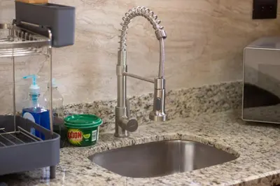 a kitchen counter with a sink in a kitchen at Cabaña Refugio Verde Arenal in Fortuna