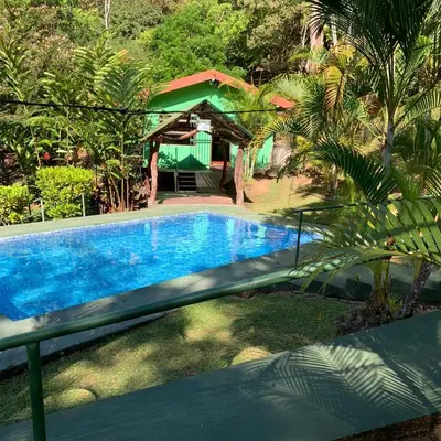 a swimming pool with a gazebo in a yard at Cabañas Luz de Luna