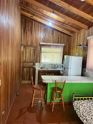 a kitchen with a table and chairs in a room at Cabañas Luz de Luna