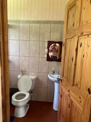 a bathroom with a toilet and a sink at Cabañas Luz de Luna