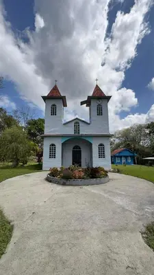a large white building with a tower on top at Cabañas Luz de Luna