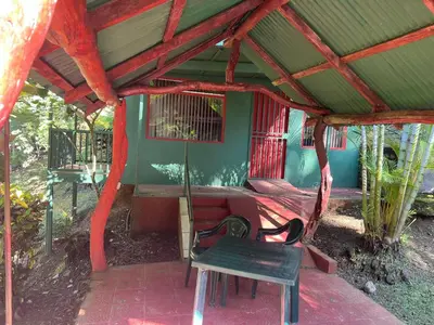 a room with a bed and a table and a chair at Cabañas Luz de Luna