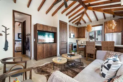 a living room with a couch and a table at Bright Modern Home with Beach Club Access and Walking Distance to the Beach in Playa Danta