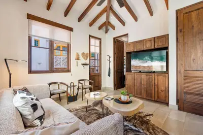 a living room with a couch and a tv at Bright Modern Home with Beach Club Access and Walking Distance to the Beach in Playa Danta
