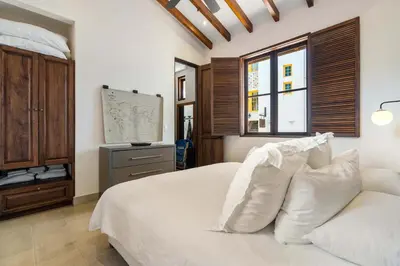 a bedroom with a white bed with white pillows at Bright Modern Home with Beach Club Access and Walking Distance to the Beach in Playa Danta