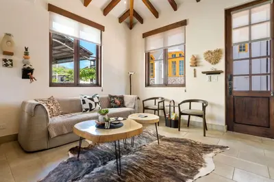 a living room with a couch and a table at Bright Modern Home with Beach Club Access and Walking Distance to the Beach in Playa Danta