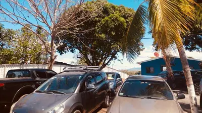 a group of cars parked in a parking lot at Casa para vacacionar Orotina in Orotina