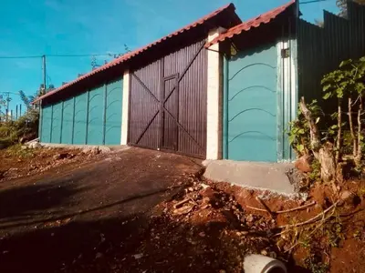 a building with a large door on the side of it at Casa para vacacionar Orotina in Orotina