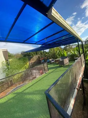 a view from the balcony of a house with a blue awning at Casa Elenia in Bahia