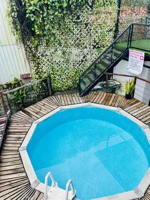 a small swimming pool on a wooden deck at Casa Elenia in Bahia