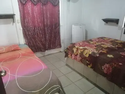 a small room with a bed and a window at Casa Elenia in Bahia