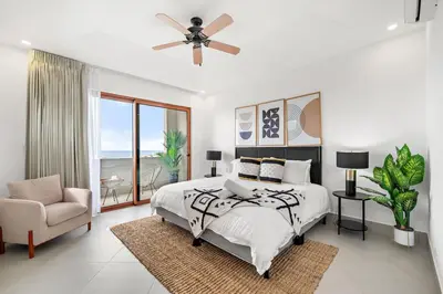 a bedroom with a bed and a ceiling fan at Panaromic Oceanview Luxury 3BR Private Rooftop in Tamarindo
