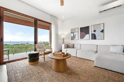 a living room with a white couch and a table at Panaromic Oceanview Luxury 3BR Private Rooftop in Tamarindo
