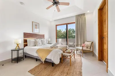 a bedroom with a large bed with a ceiling fan at Panaromic Oceanview Luxury 3BR Private Rooftop in Tamarindo