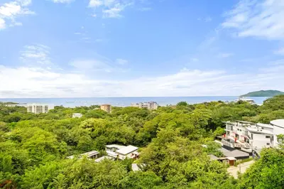 an aerial view of a city with trees and the ocean at Panaromic Oceanview Luxury 3BR Private Rooftop in Tamarindo