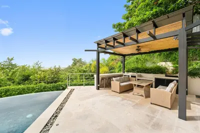 an outdoor patio with a pergola and a pool at Panaromic Oceanview Luxury 3BR Private Rooftop in Tamarindo