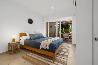 a bedroom with a king sized bed and a table at Peaceful 2BR Retreat w Pool - Near CR Best Beaches in Matapalo