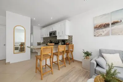 a kitchen and living room with a couch and a table at Peaceful 2BR Retreat w Pool - Near CR Best Beaches in Matapalo