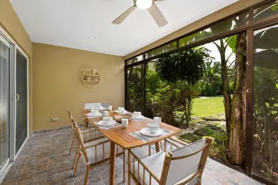 a dining room with a wooden table and chairs at Peaceful 2BR Retreat w Pool - Near CR Best Beaches in Matapalo