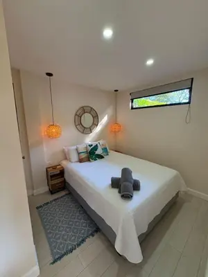 a bedroom with a large white bed with a window at Peaceful 1BR Casita with Private Deck Near Tamarindo in Tamarindo