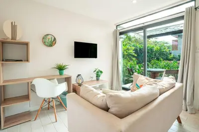 a living room with a couch and a window at Peaceful 1BR Casita with Private Deck Near Tamarindo in Tamarindo