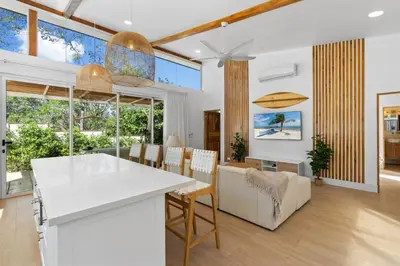 a kitchen and living room with a table and chairs at Peaceful Jungle Escape with Private Pool in Playa Grande