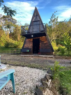 a small house with a balcony on top of it at Cabaña La paz in Alajuela City