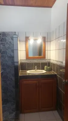a bathroom with a sink and a mirror at La Buena Vida in Nicoya
