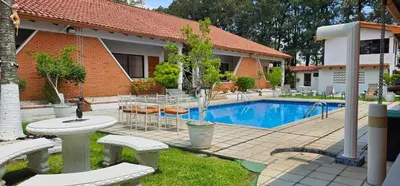 a house with a swimming pool in a yard at Apartotel Obelisco San José Aeropuerto in San José
