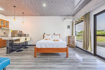a bedroom with a bed and a desk at Apartamentos Luna in Uvita