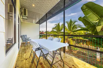 a table and chairs on a balcony with a view at Apartamentos Luna in Uvita