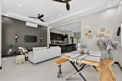 a living room with a couch and a table at Casa Dasani - Beautiful House with private pool in Santa Rosa