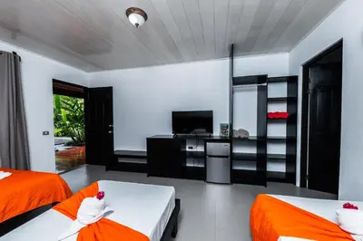 a bedroom with two beds and a tv in it at Hotel Hot Springs Sueno Dorado in Fortuna