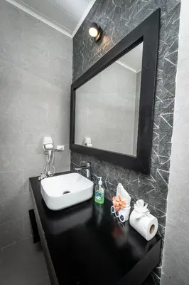 a bathroom with a sink and a mirror at Hotel Hot Springs Sueno Dorado in Fortuna