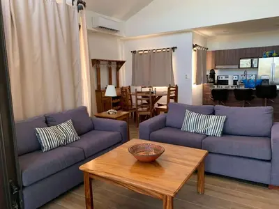 a living room with two blue couches and a table at Jungle Paradise in Santa Cruz