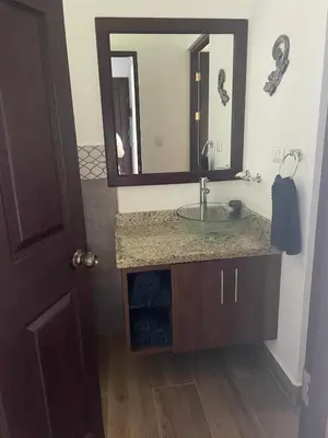 a bathroom with a sink and a mirror at Jungle Paradise in Santa Cruz