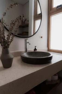 a bathroom with a sink and a mirror at The Town at Praia in Jacó