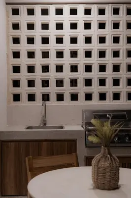 a kitchen with a sink and a table with a vase at The Town at Praia in Jacó