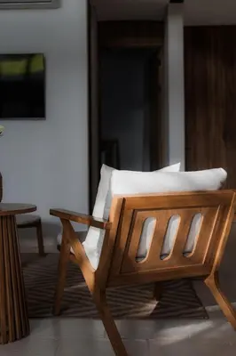 a wooden bench with a white pillow on it at The Town at Praia in Jacó