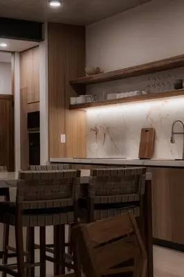 a restaurant with chairs and a bar with white marble at The Town at Praia in Jacó