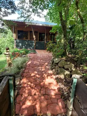 a brick walkway leading to a house at Casa Monstera Monteverde in Cebadilla