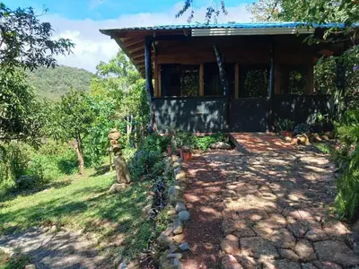 a house with a stone path leading to the front of it at Casa Monstera Monteverde in Cebadilla