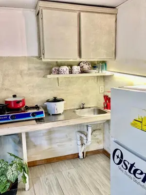 a kitchen with a counter and a sink and a refrigerator at Flamingo 107 Cabins apartment, 100mts from the beach in Playa Flamingo