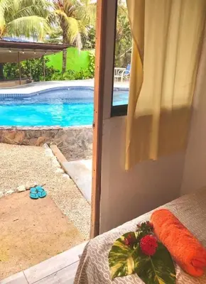a bedroom with a view of a swimming pool at Flamingo 107 Cabins apartment, 100mts from the beach in Playa Flamingo