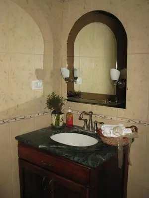a bathroom with a sink and a mirror at Toucan Villa in Caña Blanca