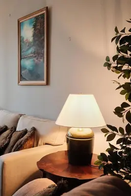 a lamp sitting on a table next to a couch at Arenal, Completely Yours Ultra Private Estate in Fortuna