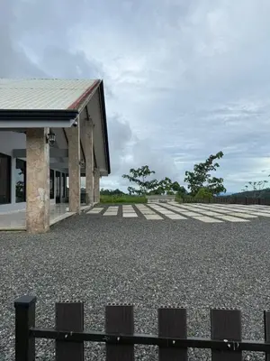 a building with a gravel parking lot with a fence at Arenal, Completely Yours Ultra Private Estate in Fortuna