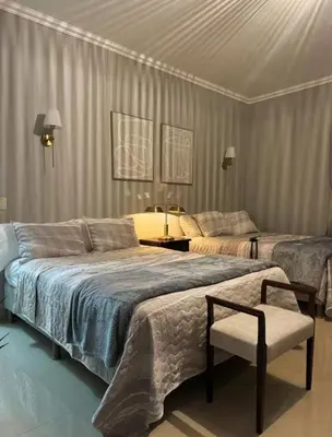 a bedroom with two beds and a chair in it at Arenal, Completely Yours Ultra Private Estate in Fortuna