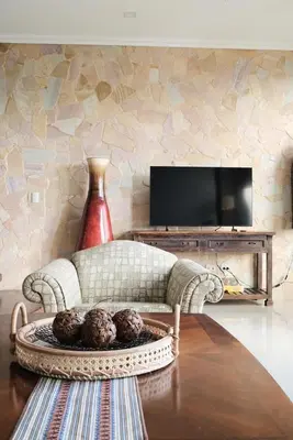 a living room with a couch and a tv at Arenal, Completely Yours Ultra Private Estate in Fortuna