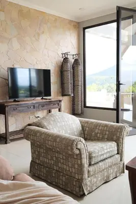 a living room with a couch and a television at Arenal, Completely Yours Ultra Private Estate in Fortuna